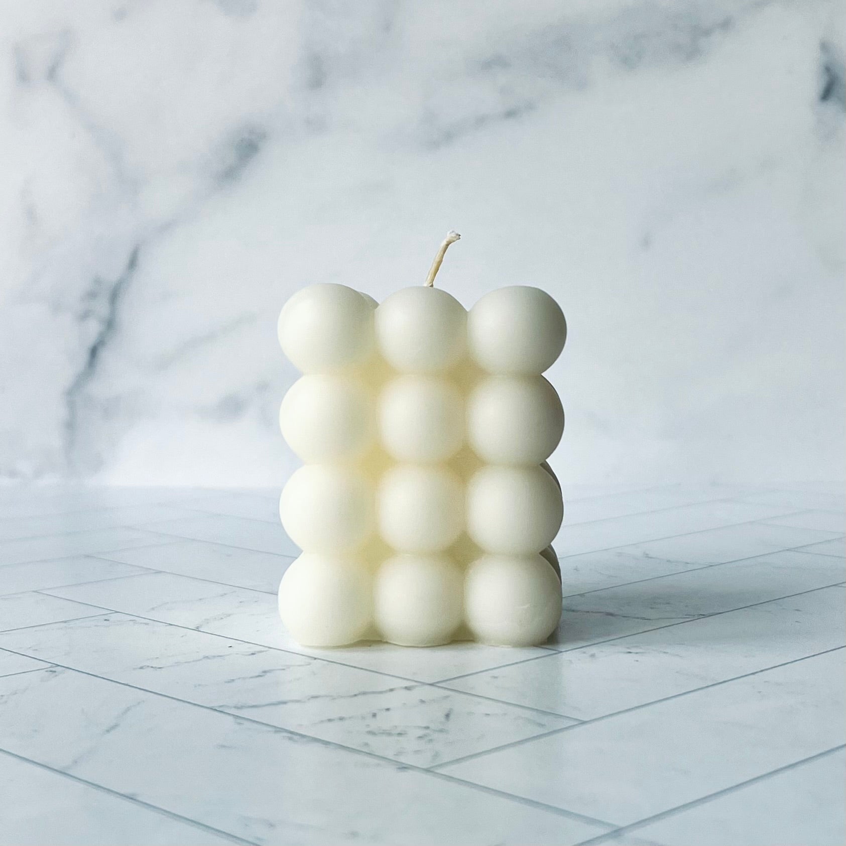 White bubble beeswax candle with four rows of bubbles