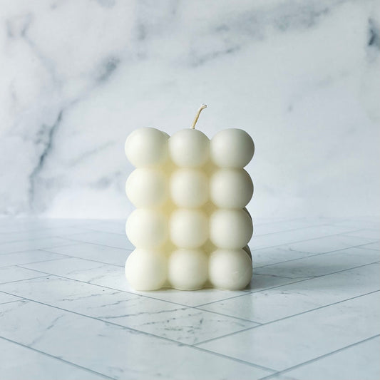 White bubble beeswax candle with four rows of bubbles