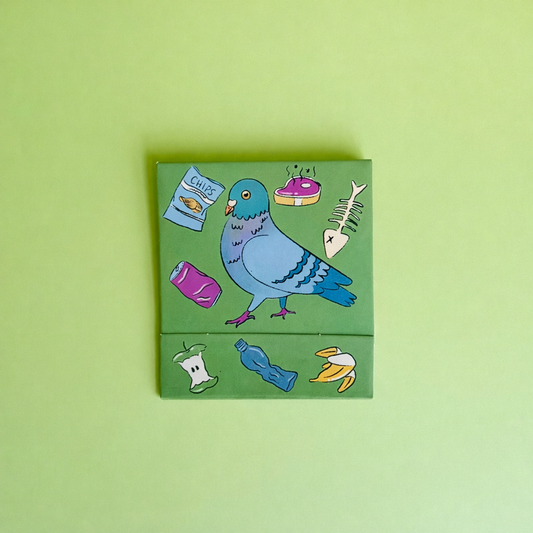 Front of City Animals matchbook depicting a pigeons with trash around it, but in a cute way