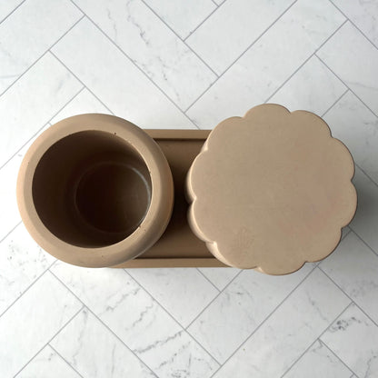 The set of Ripple Cup, Scallop Jar and Oval Tray Set in Sand shown from overhead