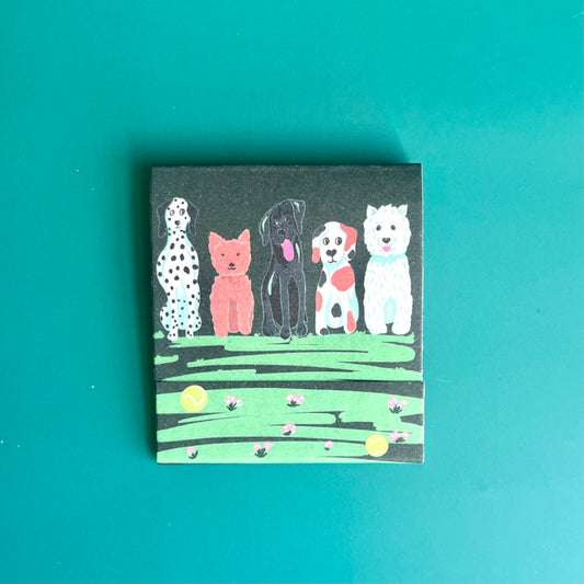 Front of dog matchbook depicting hand-drawn illustrations of dogs