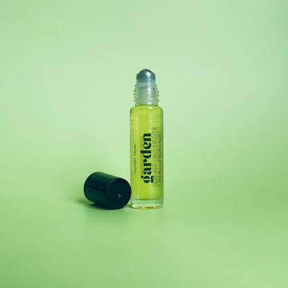 Garden perfume rollerball with lid removed next to it