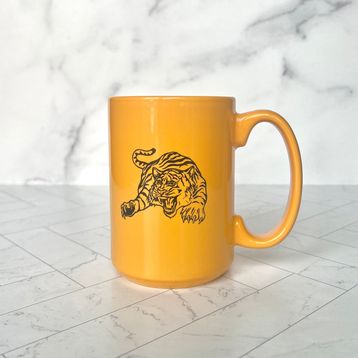 A yellow tiger mug with a handle