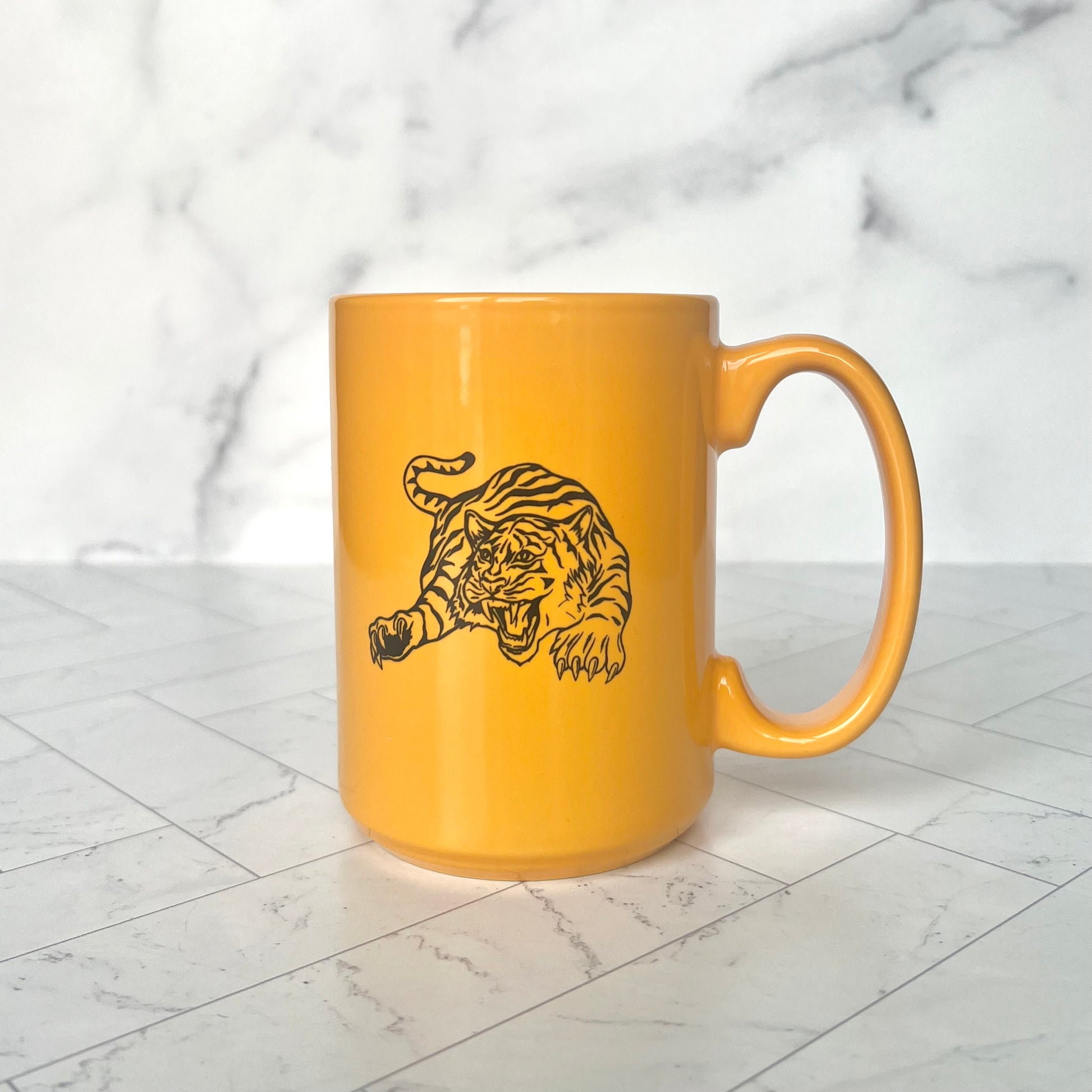 A yellow tiger mug with a handle