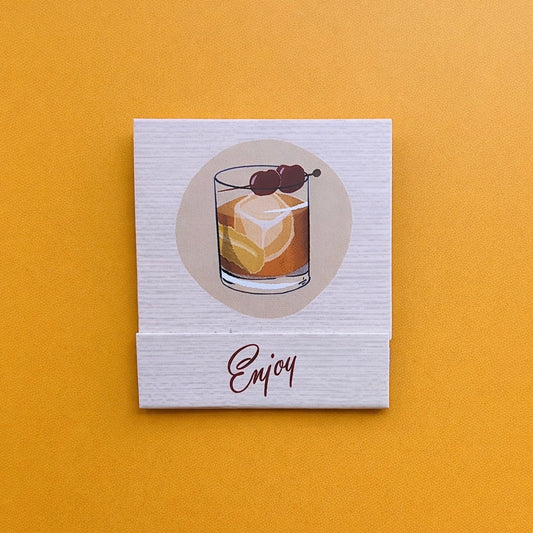 Drawing of an old fashioned cocktail in a rocks glass with the word, “Enjoy”