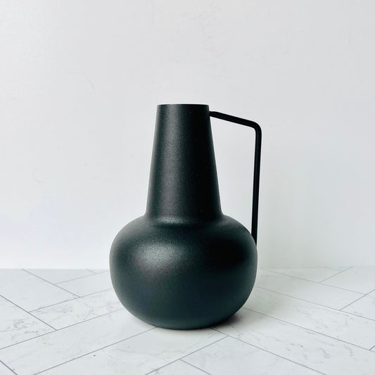 A small black bud vase with a handle