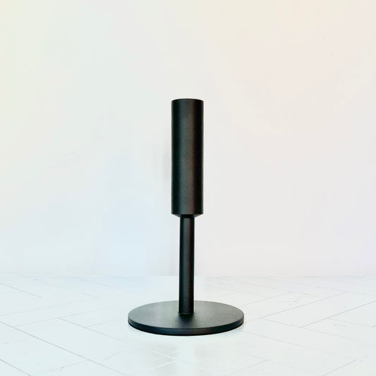 Black iron candlestick on a table