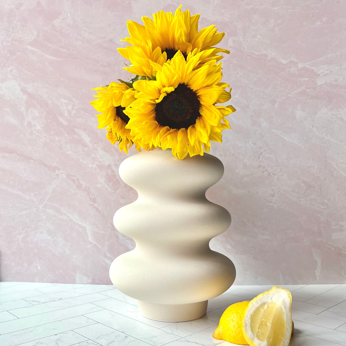The Curvy White Vase filled with sunflowers