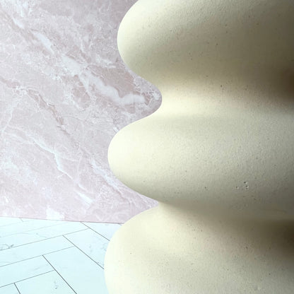 The Curvy White Vase shown up close on the side, displaying its curves up close