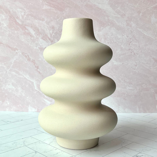 The Curvy White Vase on a table