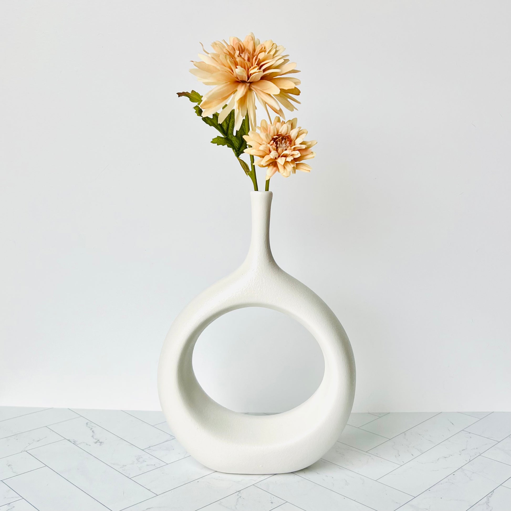 The Hollow Round Vase filled with a peach-colored flower - Humble Abode