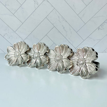 A set of the four Silver Flower Napkin Rings that come in this item