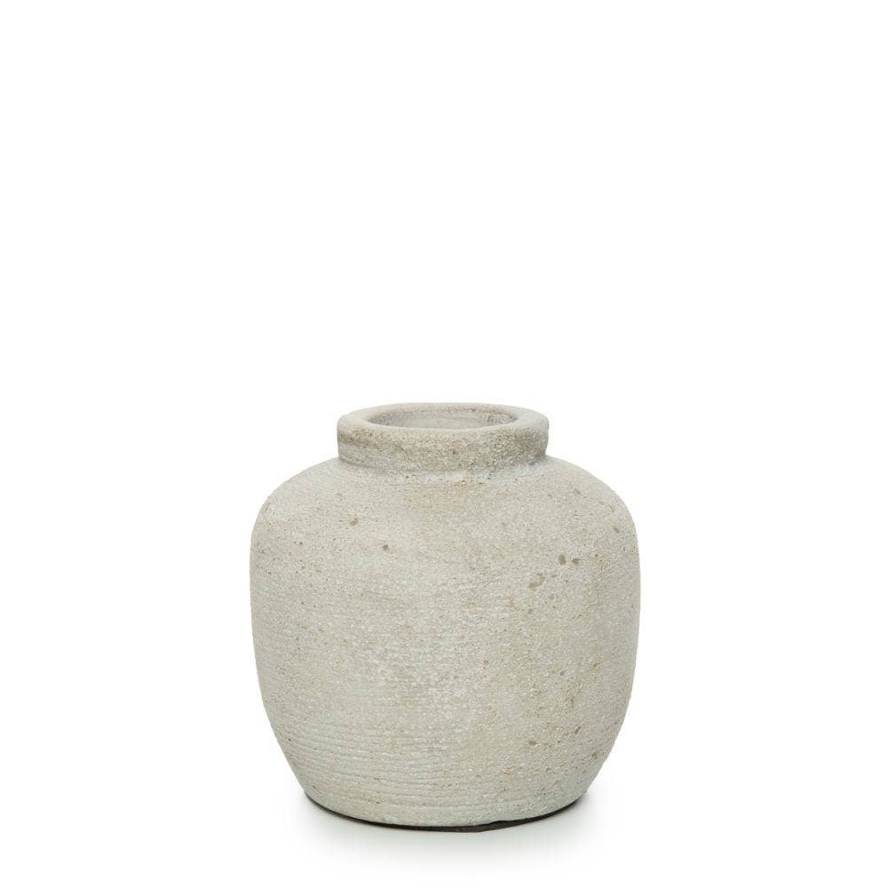 The Petite Concrete Vase against a black background