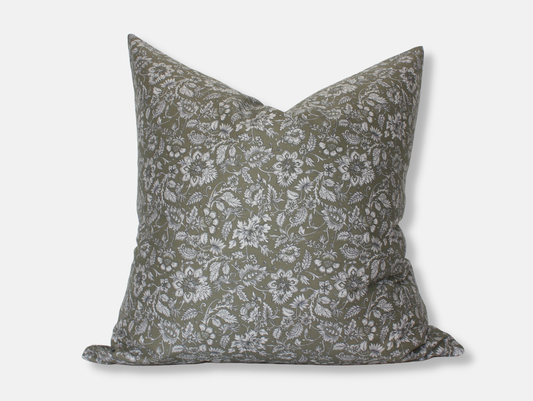 A pillow cover with insert shown against a blank background. The pillow is a rich olive color with a light-gray floral pattern outlined in black all over it.