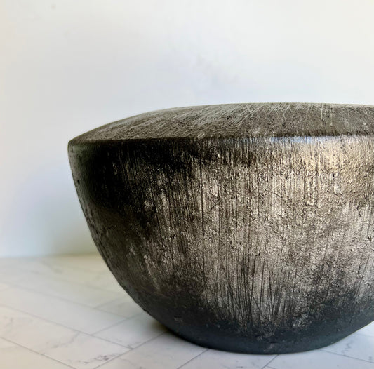 A silvery/charcoal-gray colored pot showing the angle of the planter