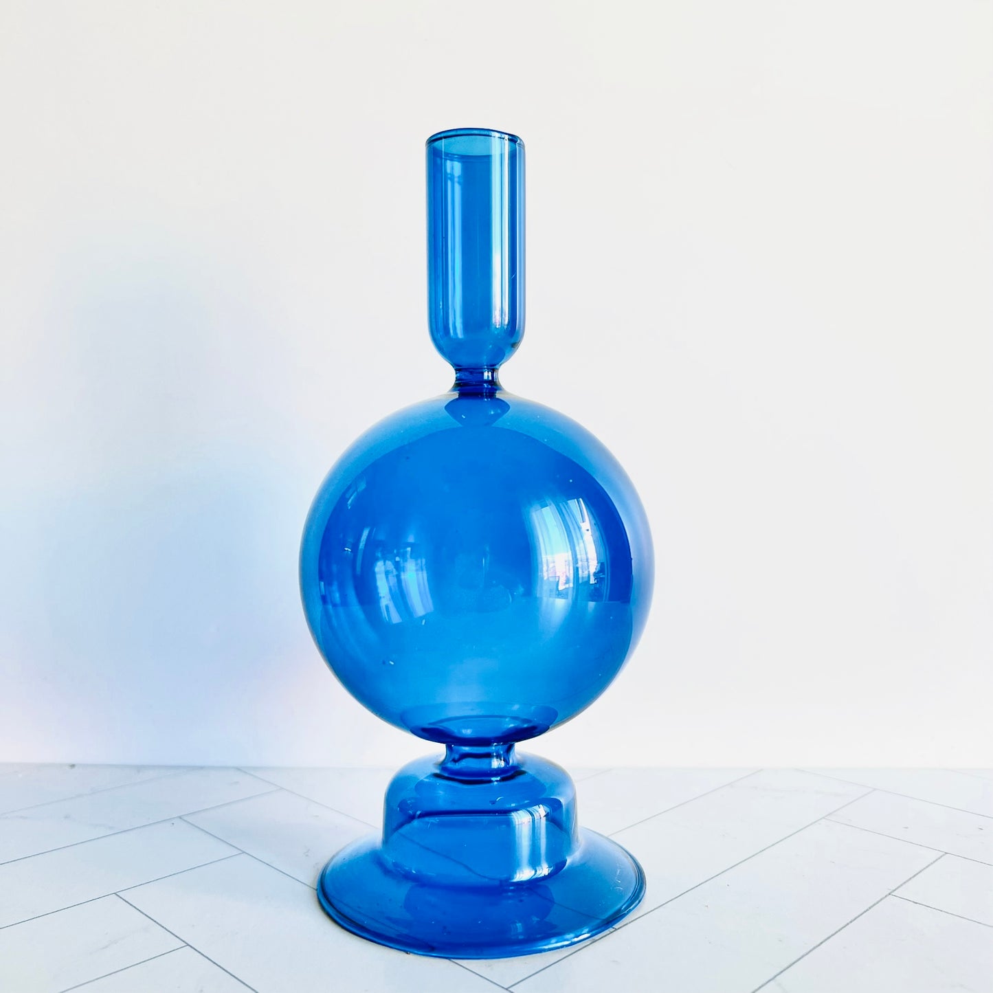 The Cobalt Candlestick shown on a table by itself