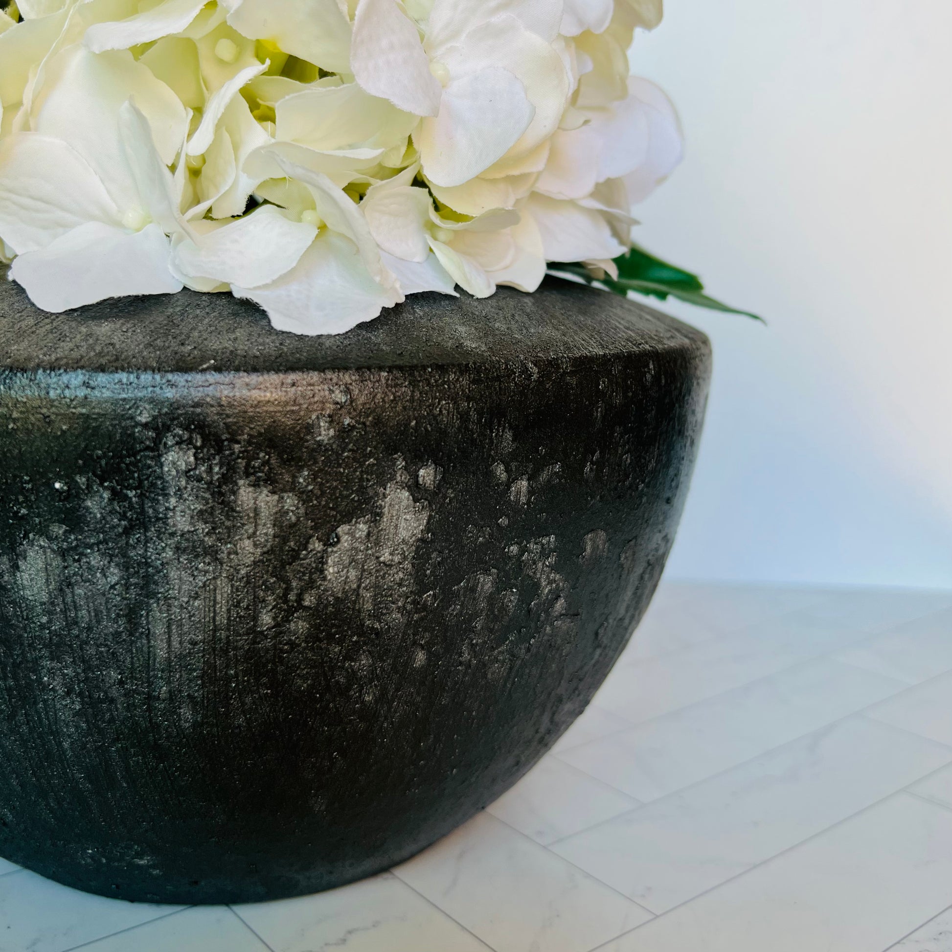 The Patina Planter shown up close and filled with hydrangea blossoms