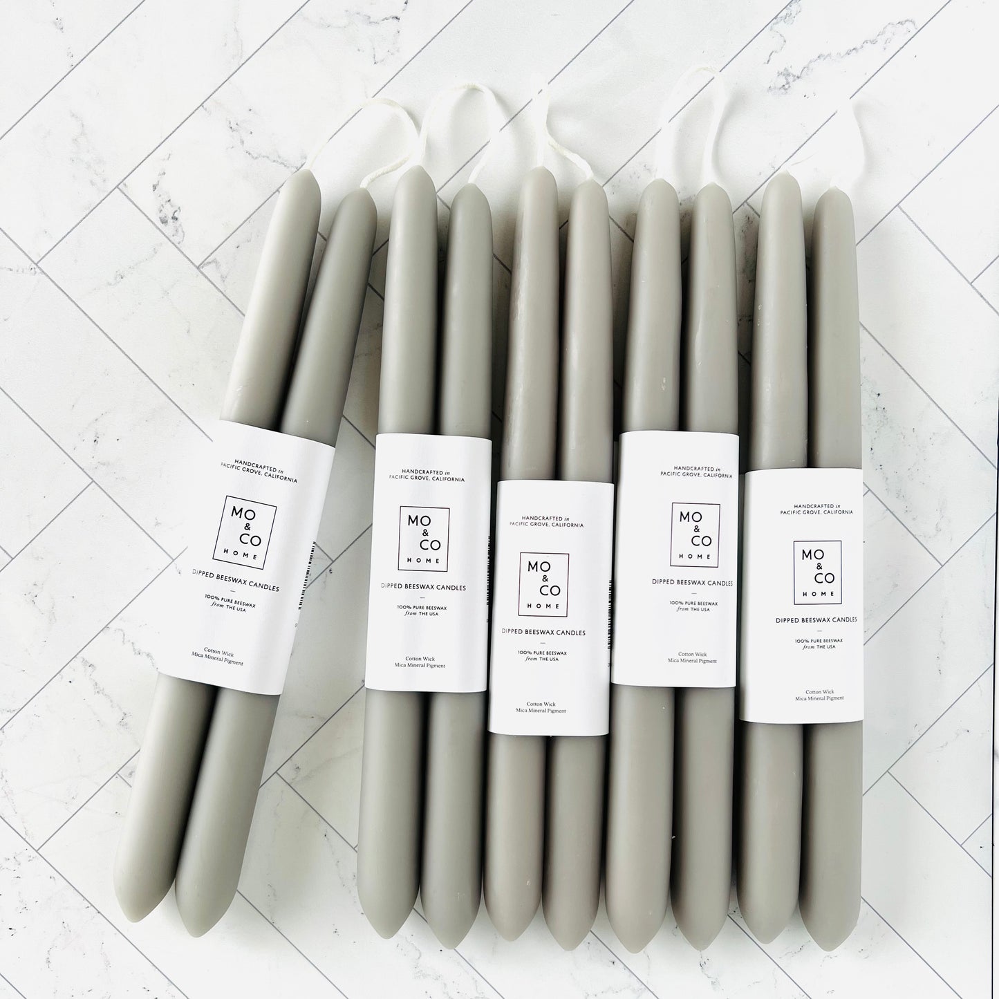 Six sets of gray taper candles