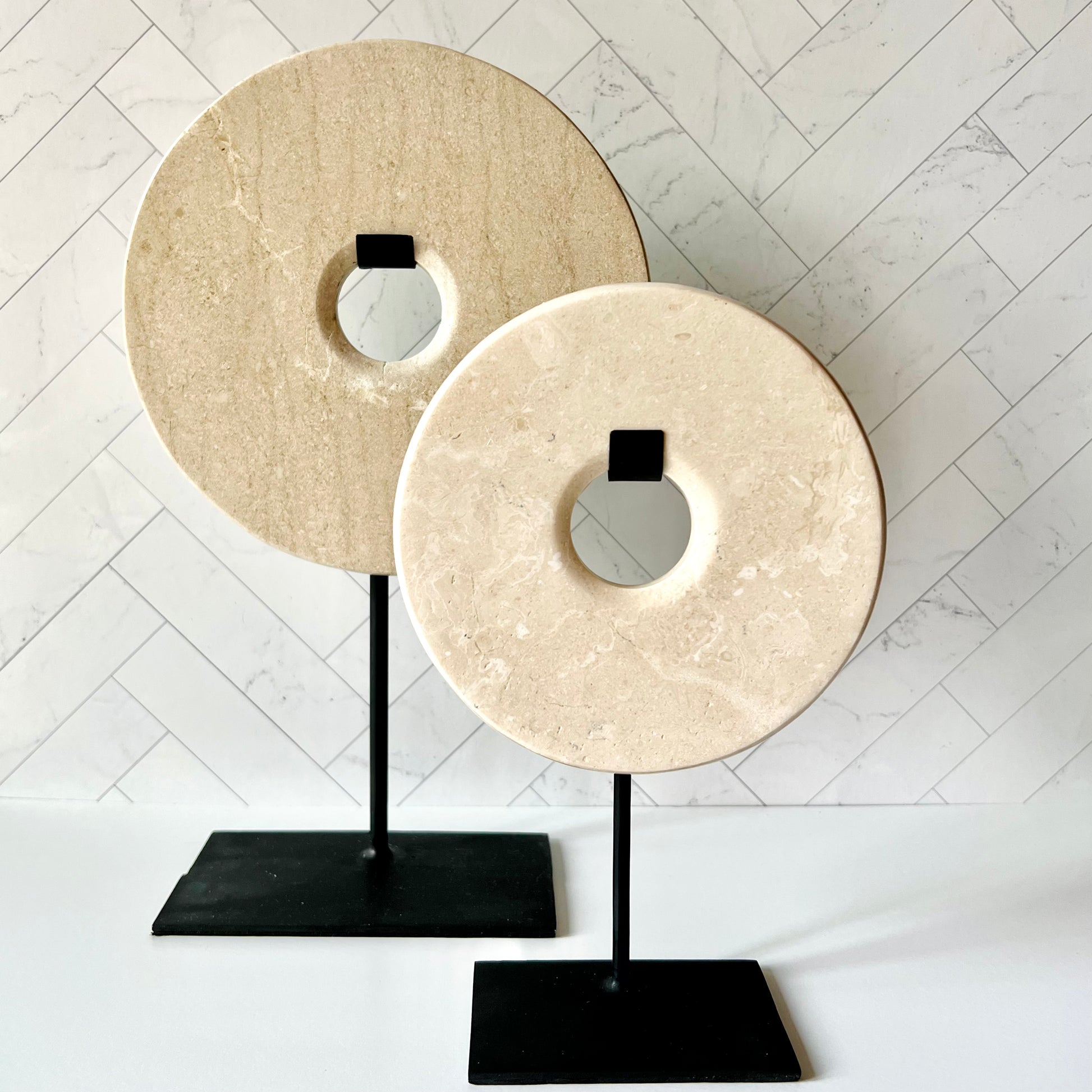 The Standing Beige Marble Disc (small) with its larger counterpart behind to show their size difference