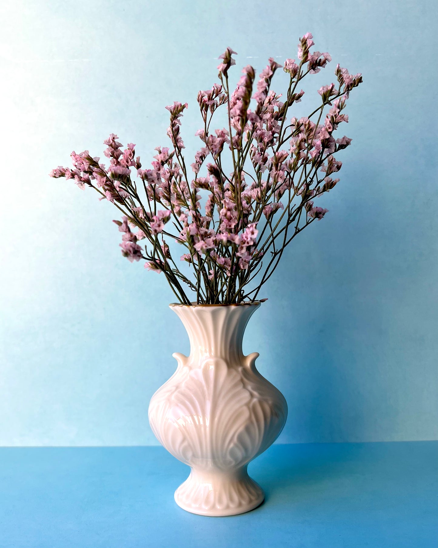 The vintage bud vase filled with little pink flowers