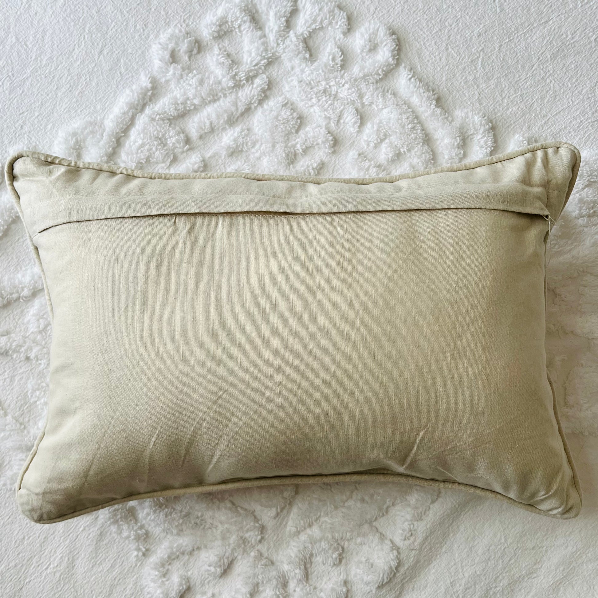 The back of the Eloise Embroidered Pillow Cover showing its zipper closure