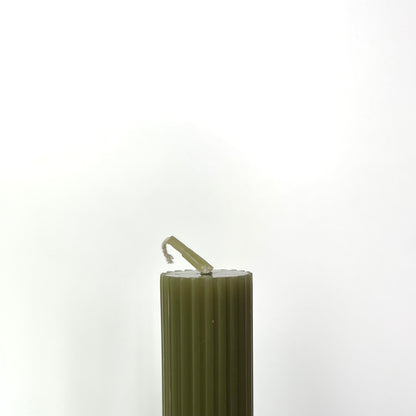 The top of one of the Roman Taper Candles in Sage showing its smooth, flat top