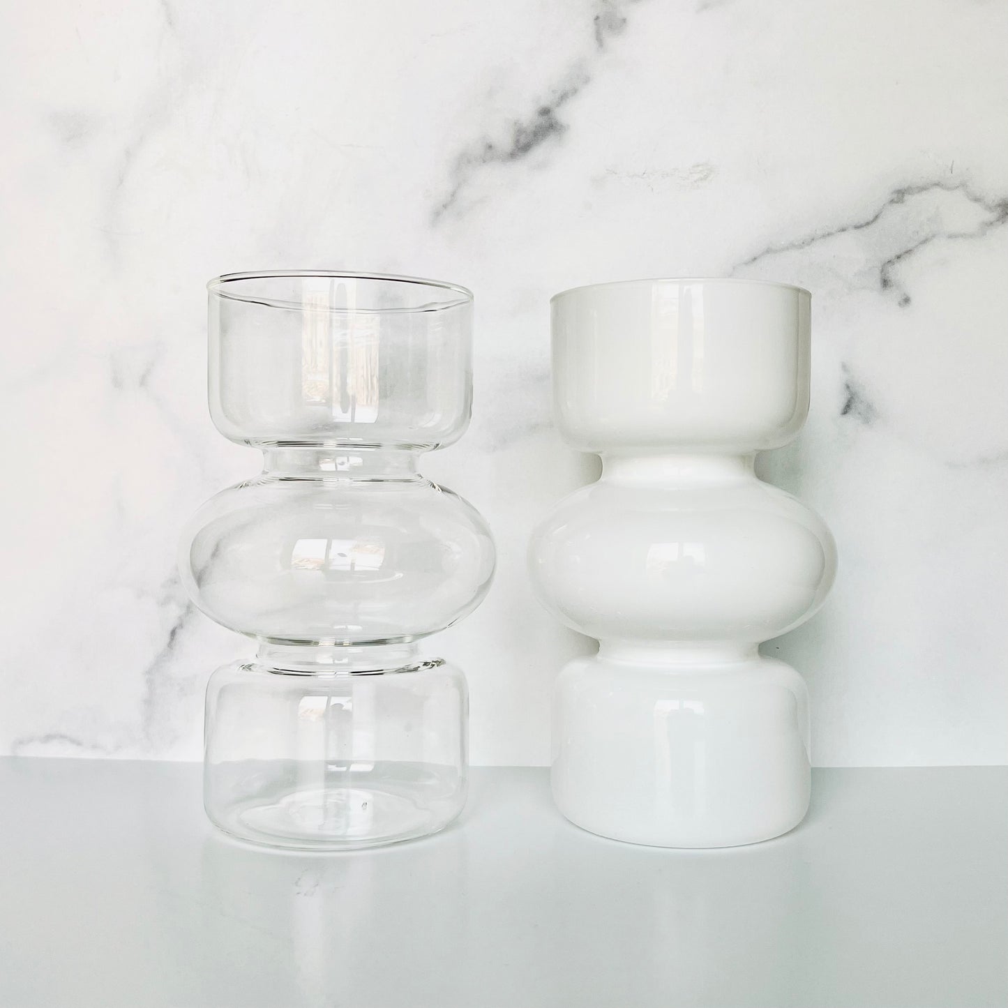 The Curvy Glass Vase shown in clear and white