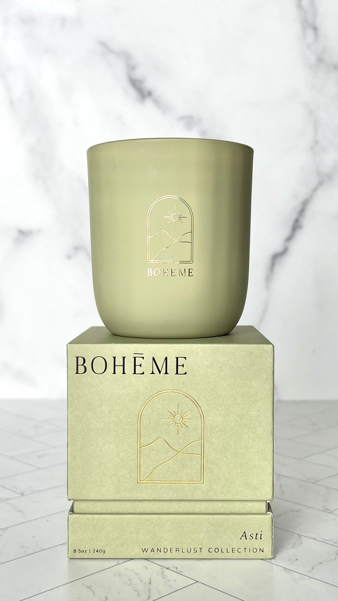 The Scented Candle in Asti stacked on top of its box showing is brand, Boheme