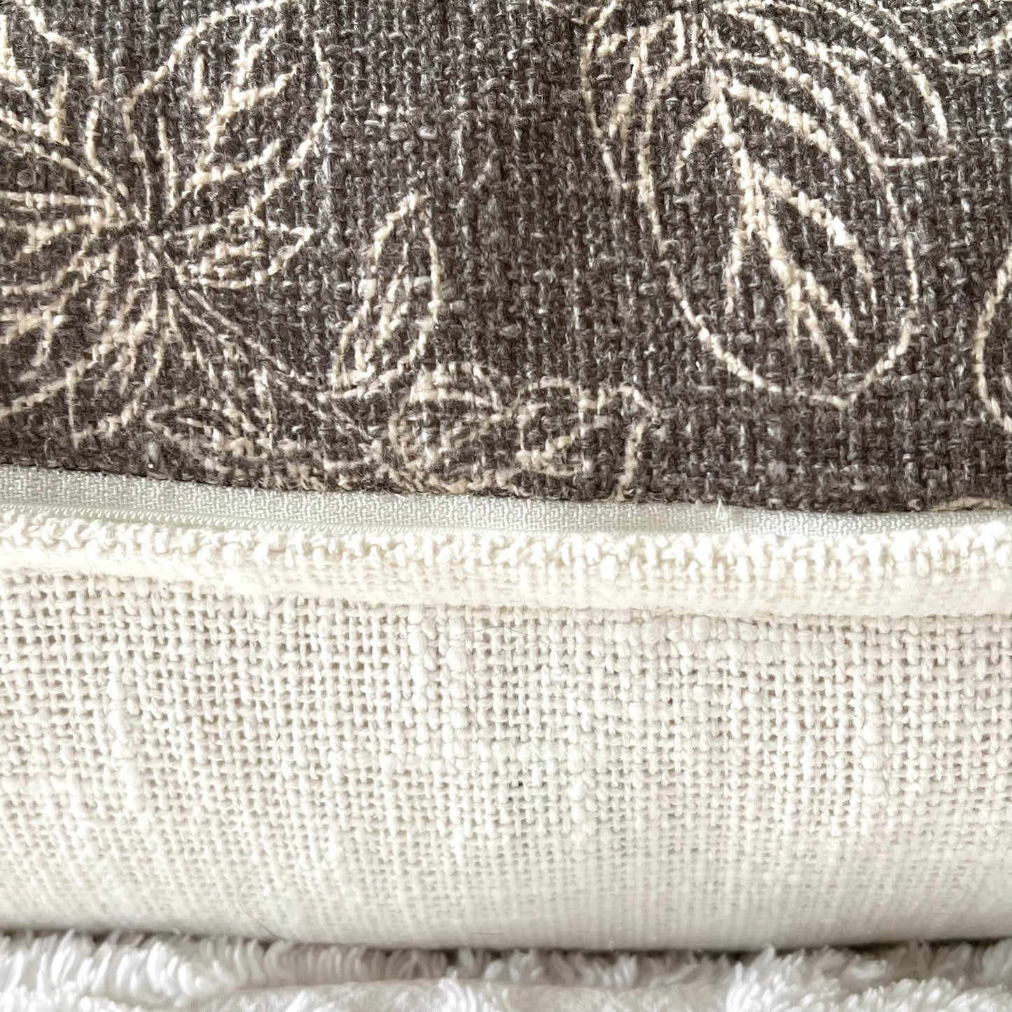 A close up of the zipper closure of the Emma Pillow Cover